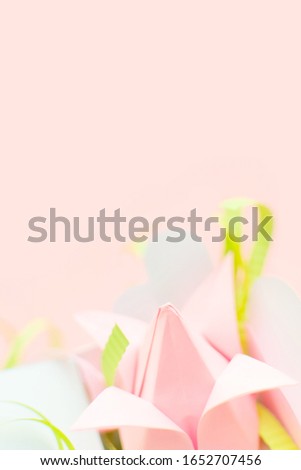 Closeup composition of pink Origami paper tulip with green decorations in white box-heart on pink background. Copyspace. Happy Women's Day, March 8, Mother's Day, Mom's day. Greeting card. DIY concept