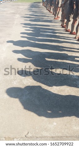 Shadow of The silhouette of Scout standing in line.
