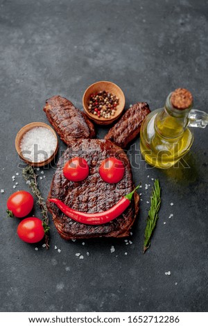 Grilled Easter steak with spices. Easter bunny on stone background with copy space for your text.