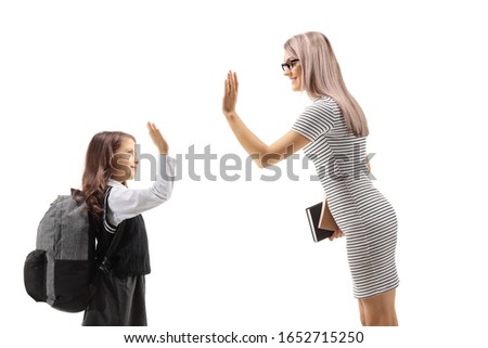 Woman making a high-five with a schoolgirl isloated against white background