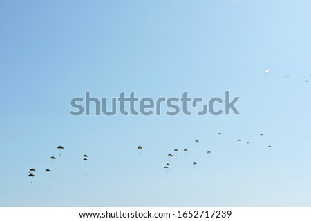 A paradrop of Czech and Polish paratroopers during Nato Days in Ostrava, the Czech Republic, blue sky in the background