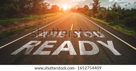 Are you ready written on highway road in the middle of empty asphalt road at  beautiful blue sky. Royalty-Free Stock Photo #1652754409