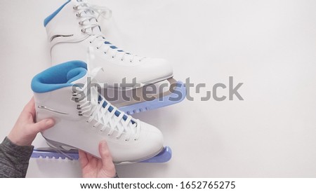 Flat lay. New figure skates on a white background.