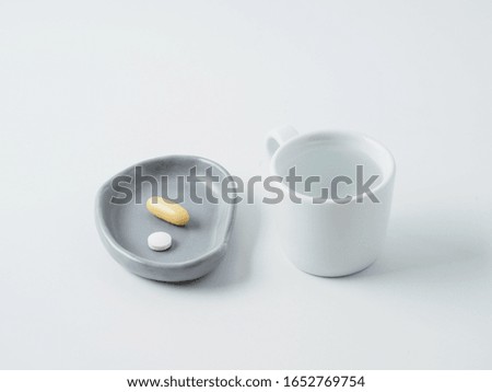 Medical pills in the plate isolated on white background.