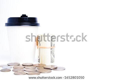 A picture of fake money, paper cup and coin for business deal concept.