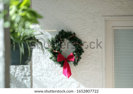 Christmas Wreath Next to Patio Door On Wall