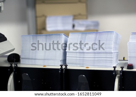 two piles of white paper envelopes ready for printing Royalty-Free Stock Photo #1652811049