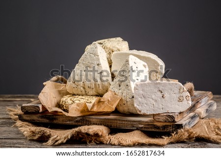 The concept of eco products. Organic farm dairy products, cheeses, cereals. Parmesan, feta, goat cheese, red wine. Background image. Copy space.