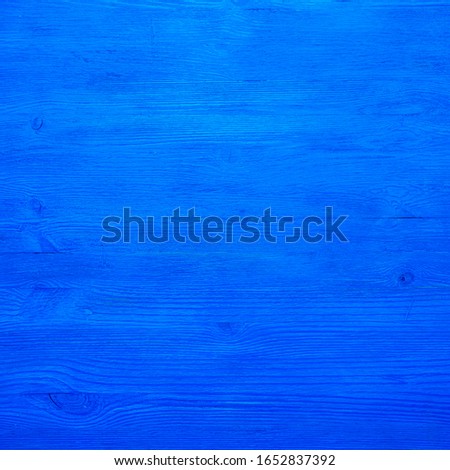 The background is wooden boards, blue saturated color.