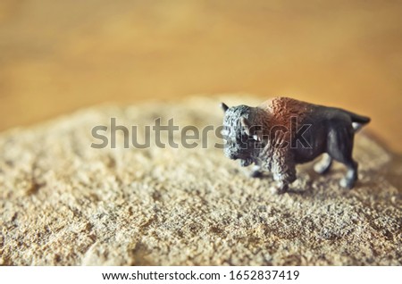 Miniature Toy Buffalo / Bison Standing on a Rock