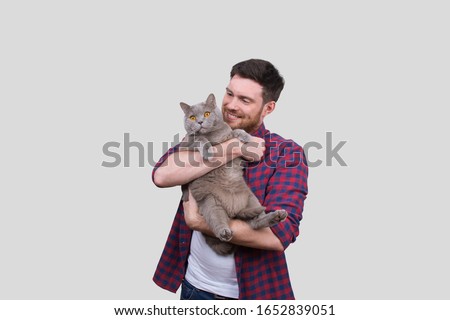 Man Holding Cat in Hands. British Gray Cat. Man with Cat Smiling. Isolated Royalty-Free Stock Photo #1652839051