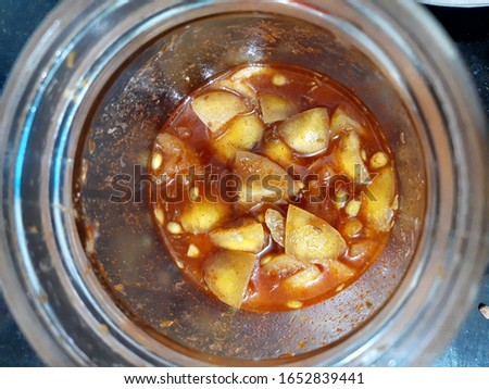 Lime Pickle in transparent glass jar made in India