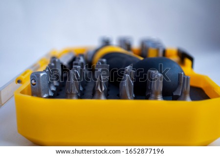 Equiped Tool Kit. Instrument. Miter heads and keys. compact set in a yellow plastic box with a transparent cover.tools kit detail close up