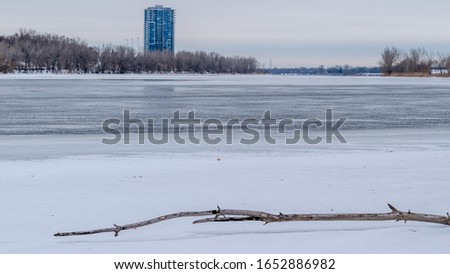 apartment building in town with frozen lake in winter