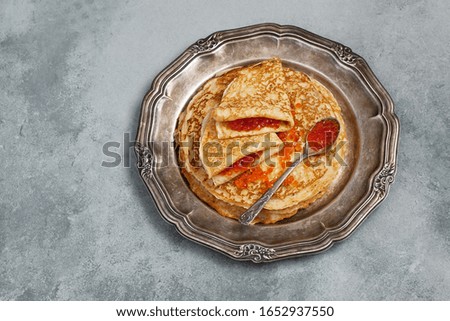Golden crepes with red caviar for  traditional Russian winter holidays - Maslenitsa, pancake week. Top view, flat lay