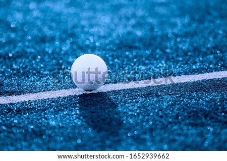 White ball for playing field hockey. Blue filter