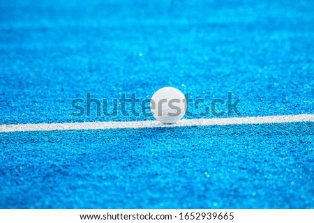 White ball for playing field hockey. Blue filter