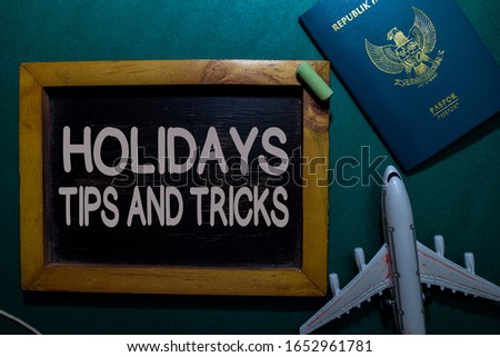 Holidays Tips and Tricks write on a black board isolated on Office Desk
