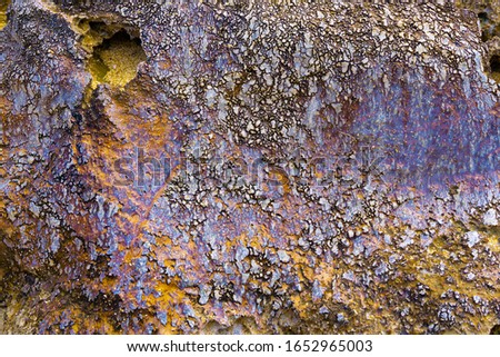 Background texture and wall paper of vivid colored glass formed on rock made by volcanic heat. 