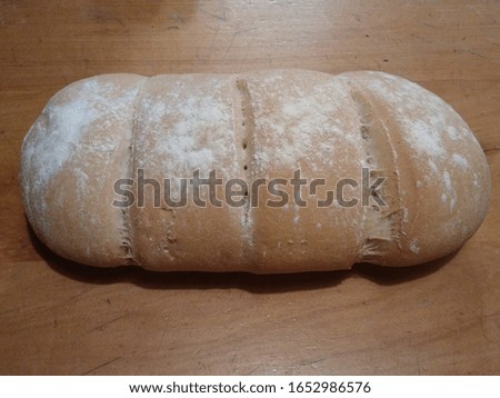 Just bread on a table. Horrible photo made in 1 second with mobile phone that is accepted, while rejecting photos that are packaging photos with a full day of production and hours of post production.
