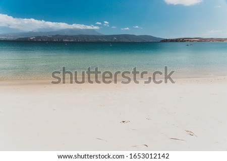 landscape in Opossum Bay Beach on a sunny summer day with nobody on the beach with deep blue water and clear skies enhancing the beautiful coastline and shores
