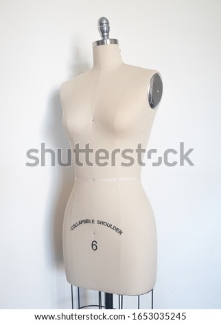 fashion dressmaking mannequin in front of a white background