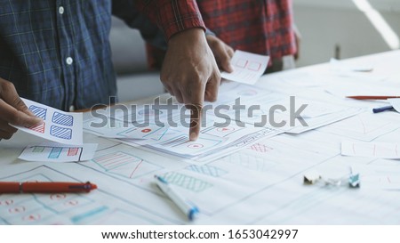 Designers man drawing (UX) (UI) Graphic designer creative sketch planning application process development prototype for responsive web desig Royalty-Free Stock Photo #1653042997