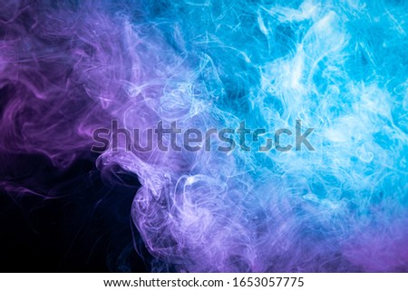 Toxic movement of color smoke abstract on black background, fire design. Fantasy pink  and purple smoke abstract on black background. 