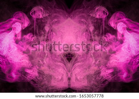 Dense multicolored smoke of   pink,yellow and purple colors in the form of a skull, monster, dragon on a black isolated background. Background of smoke vape. Mocap for cool t-shirts

