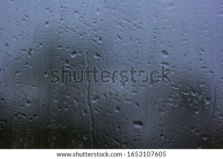 Rain drops on the glass surface.