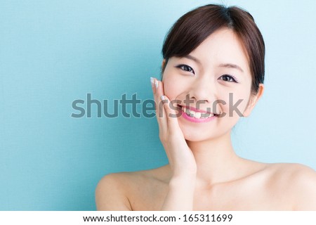 attractive asian woman skin care image isolated on blue background Royalty-Free Stock Photo #165311699