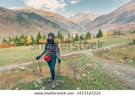 Asian woman is hiking in colorful nature scenic of forest and hills.