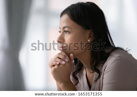 Thoughtful African American young woman look in distance pondering or remembering, pensive biracial millennial female lost in thoughts feel stressed troubled, thinking of problem solution Royalty-Free Stock Photo #1653171355