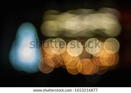 Bokeh neon glittering shop windows. Blurred image of neon light in a shop window at night in the city. Bokeh elements. Creative background for montage and design.