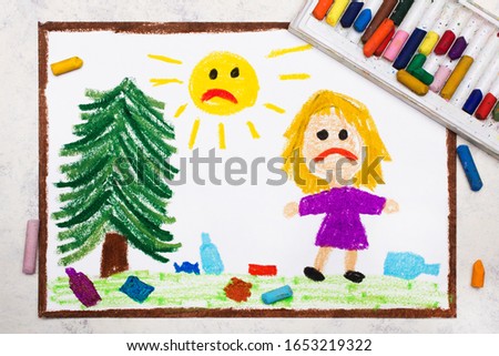 Sad girl is looking at trash in the meadow. Ecological problem of littering the planet . Photo of colorful drawing. 