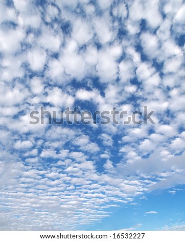 Fluffy clouds in blue sky, great for background.
