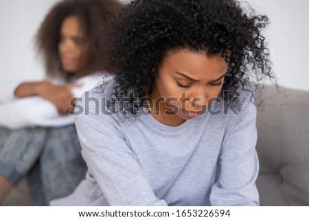 Upset african american mom of difficult teen child puberty daughter feeling offended sad after family fight, depressed single parent black mother thinking of conflict argument with teenage daughter Royalty-Free Stock Photo #1653226594