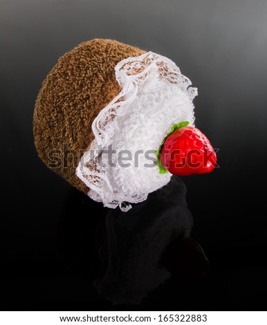 strawberry cake made from hand towel on dark background