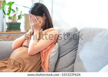Pregnant women are crying, upset She was not ready for pregnancy.
 Royalty-Free Stock Photo #1653239626