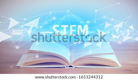 Open book with STEM abbreviation, modern technology concept