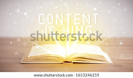 Open book with CONTENT IS KING inscription, social media concept