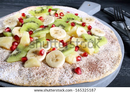 pizza with fresh fruit gray background