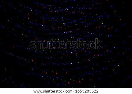 Neon lights in a disco. Isolated on black background, glare. night view, neon light, rays. Celebratory background. star Rain