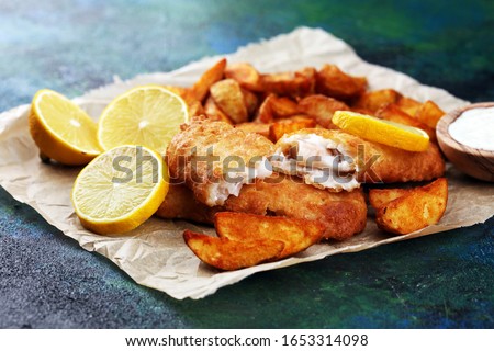 traditional British fish and chips consisting of fried fish, potato chips. fish to takeaway