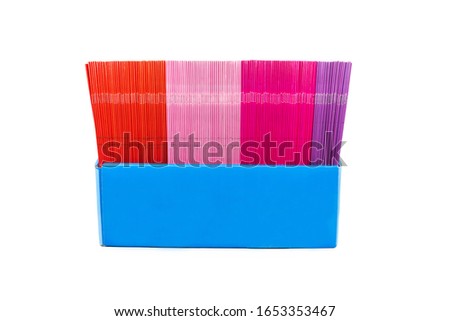 Set of colorful books in blue carton box isolated on white background
