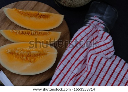 
Cantaloupe on the black wooden floor in the kitchen