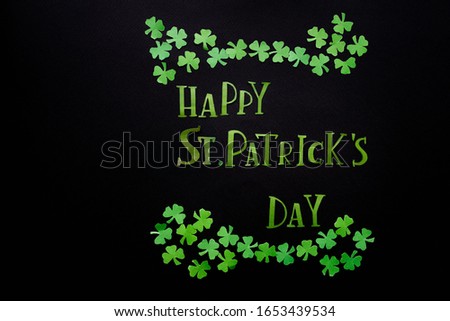 St Patricks Day Flat Lay including lettering and shamrocks on black background