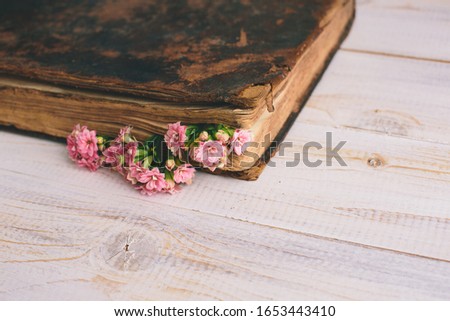Vintage books with bouquet of flowers/ nostalgic vintage background
