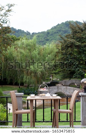 Afternoon tea in the garden set with desert. mountain is background 