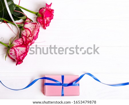 Beautiful bouquet of roses and pink box isolated on white background. The concept of the holidays
